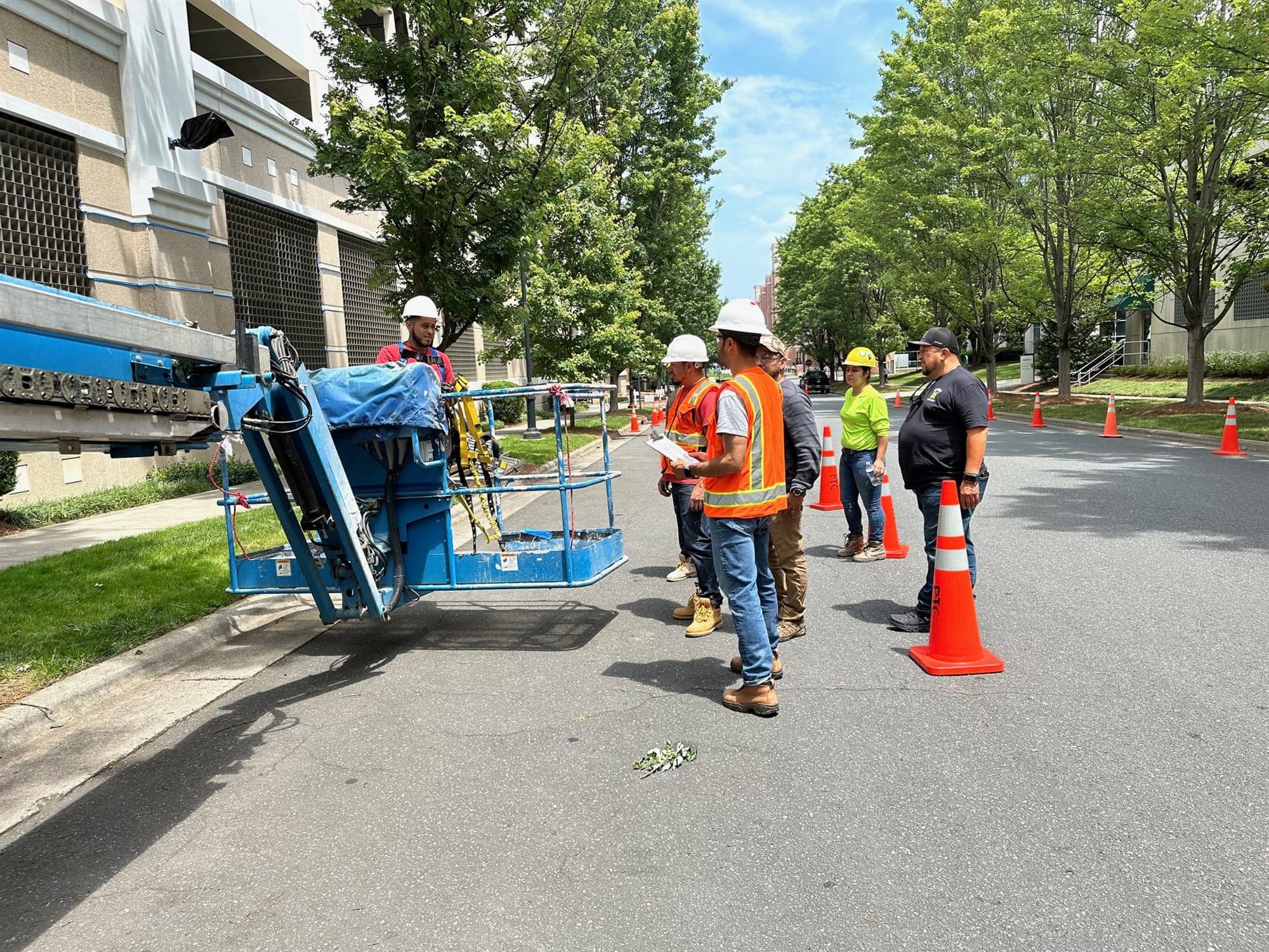 Edwin Cueva leading aerial lift safety training for a construction crew on a jobsite in Charlotte, North Carolina